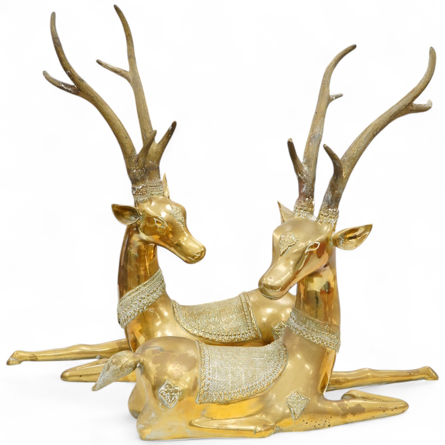 A pair of modern Chinese polished bronze 'Feng Shui' models of antlered recumbent deer with decorated bodies, height 66cm